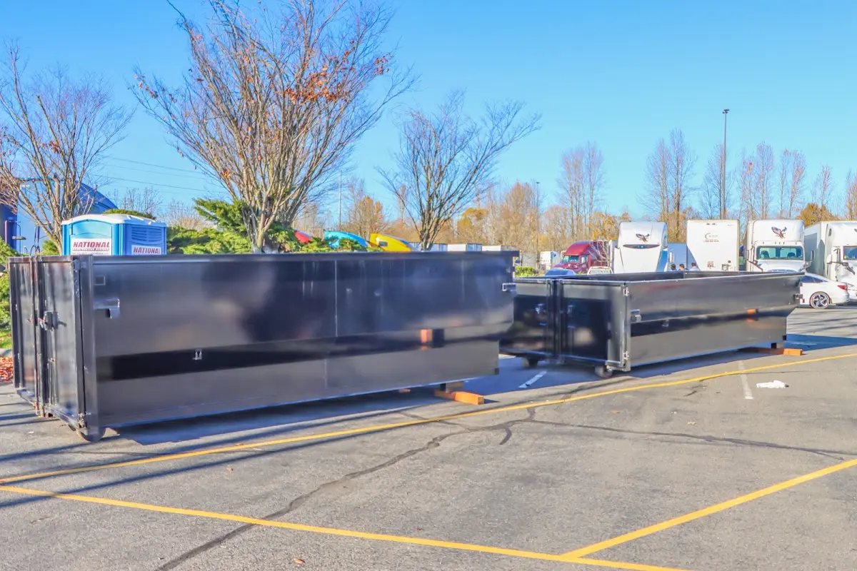 Professional dumpster rental service with roll-off container on residential driveway in Fallbrook